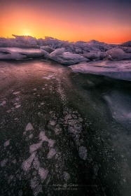 Sun rising over ice stacks and bubbles WI10274